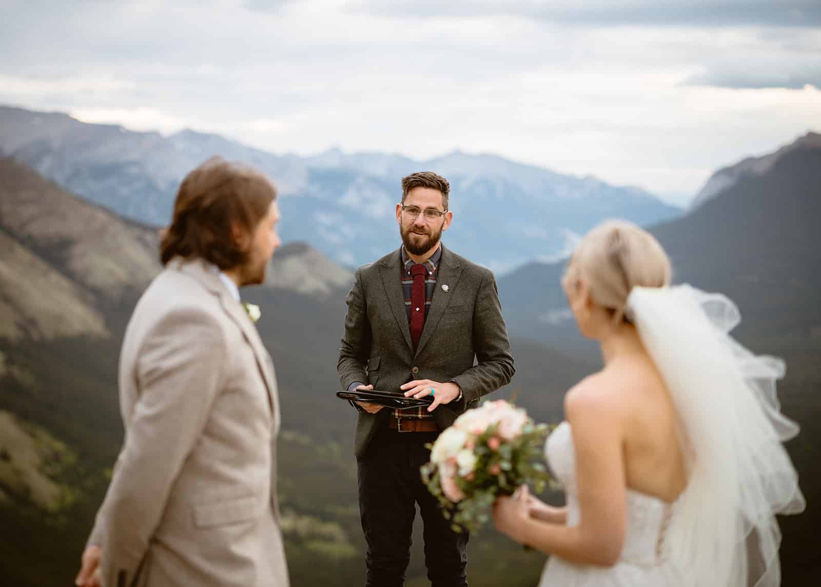 Couple exchanging vows in stunning landscape.