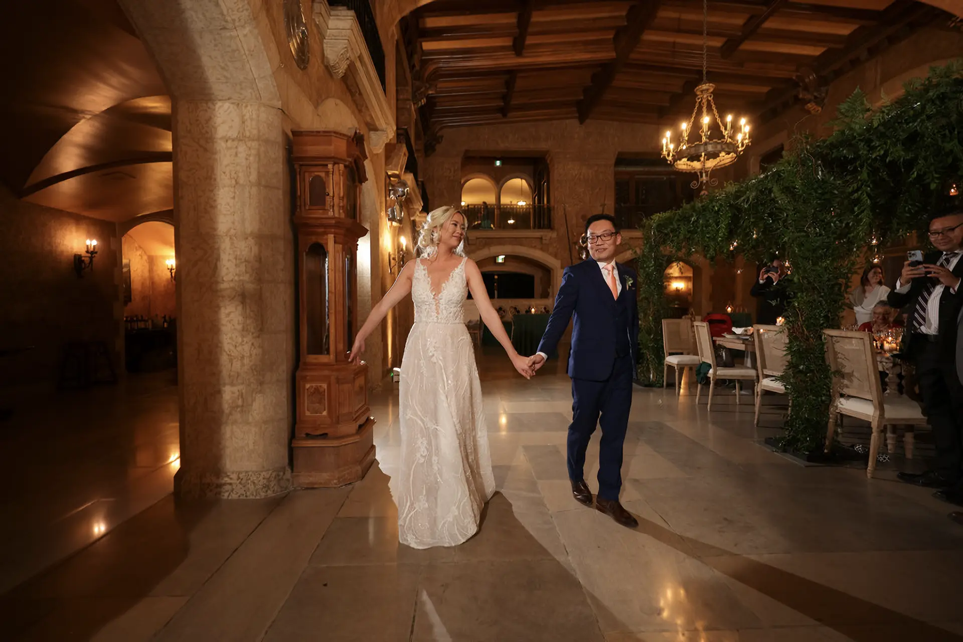 A bride and her father walking down a treed aisle at the Coutts Centre for Western Heritage